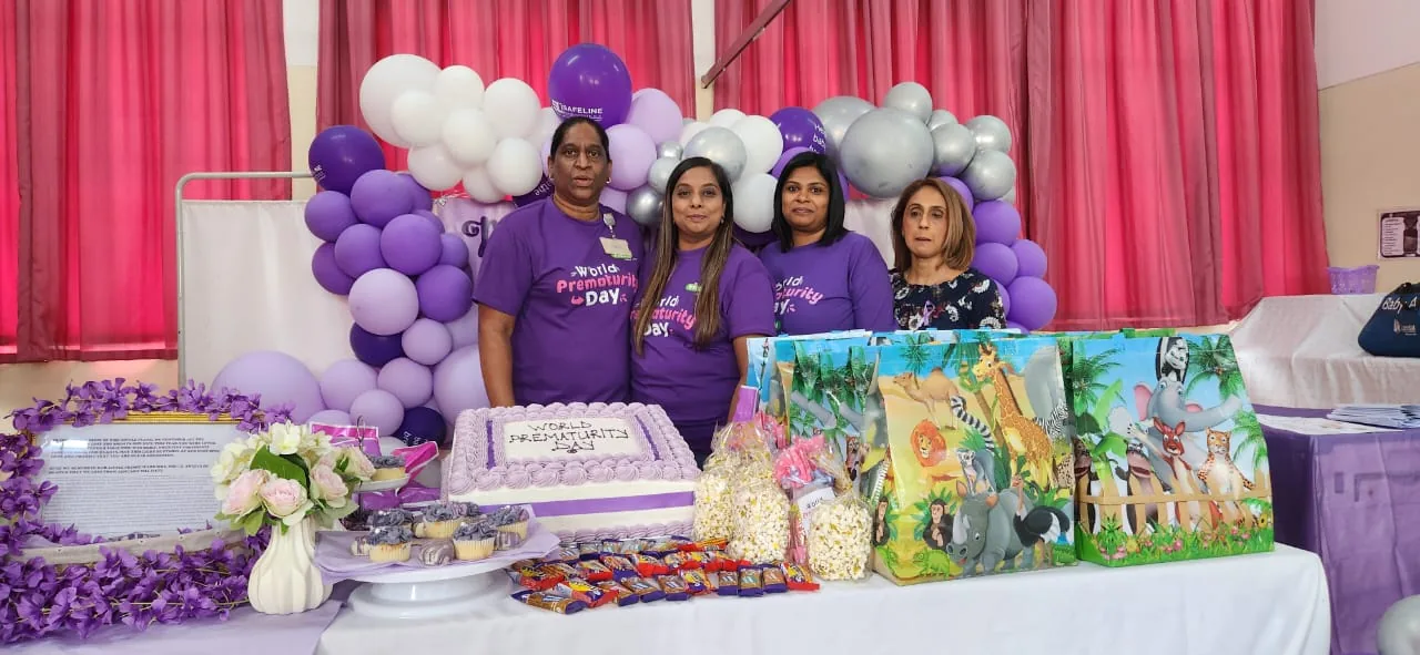 Nurses and volunteers with donated baby items at a community outreach event